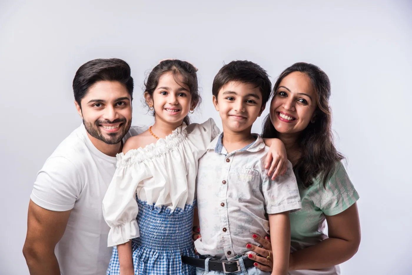 Dr. Nikitaa's patients — a father with his two smiling children, treated at Little Bites Clinic, Sector 29 Faridabad